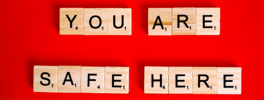Scrabble tiles that spell out "You are safe here"